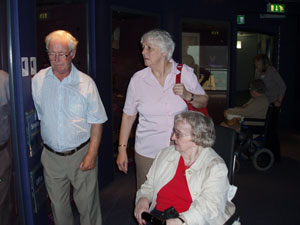 Photograph showing Alan, Maureen and Betty checking out a display